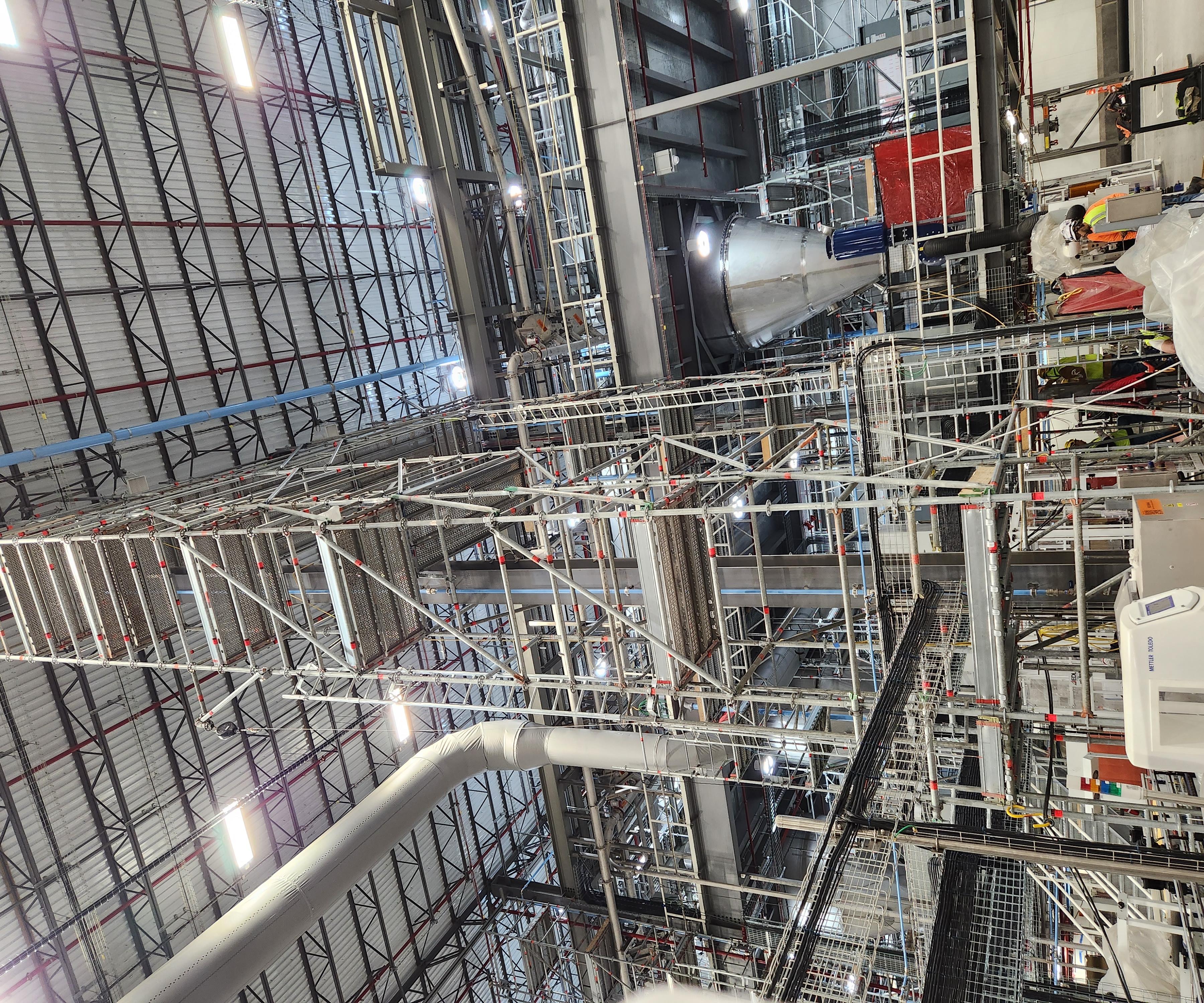Interior scaffold tower installed around industrial facility equipment