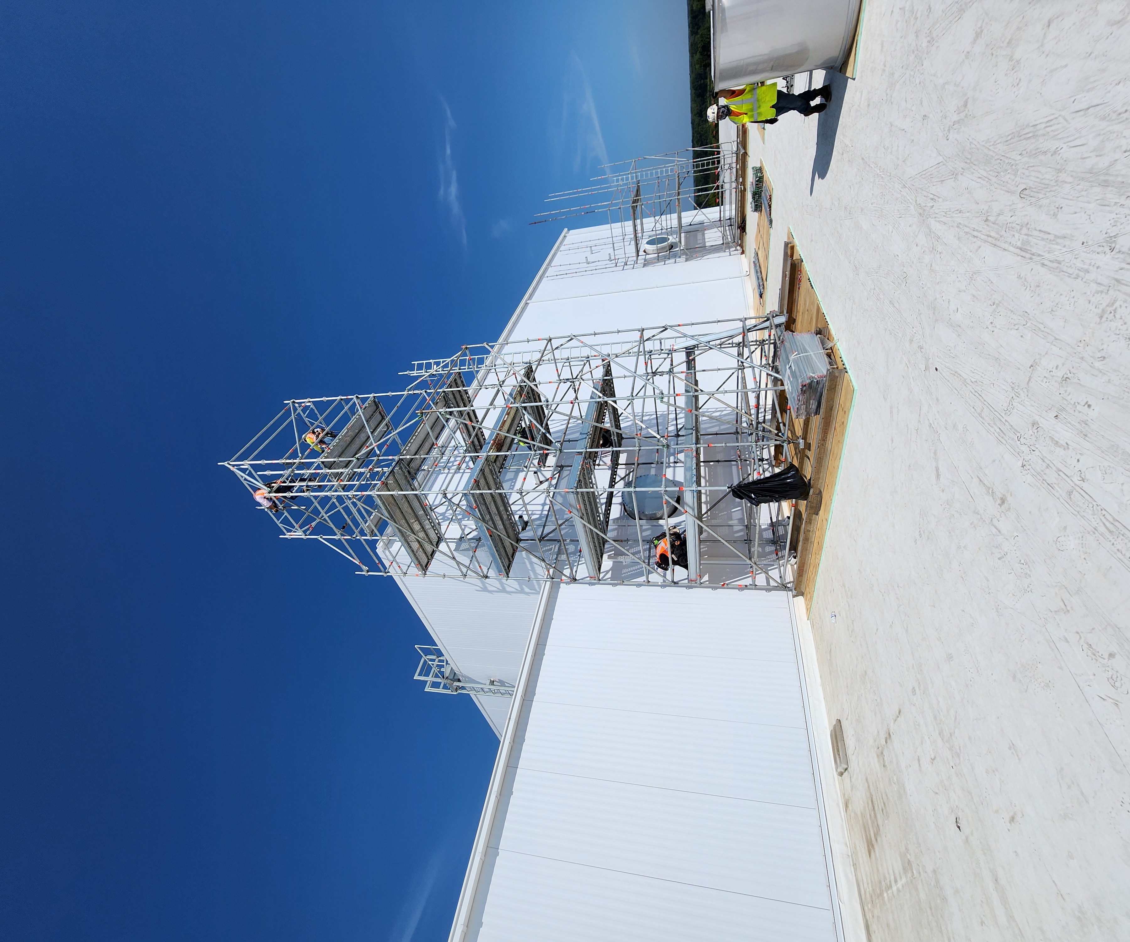 Rooftop scaffold tower with workers completing elevated access work